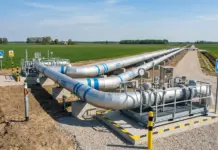 Poland Okays Launch of First Hydrogen Network Operator of EU Hydrogen gas pipeline station in a rural field with large silver pipes and safety signs.