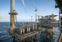 Green Hydrogen Production on Operational North Sea Platform Offshore energy platform featuring wind turbines and an industrial rig over the blue ocean sea.”